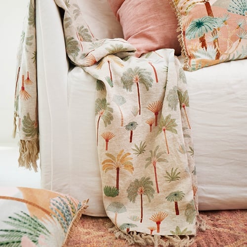 Karina Jambrak x Adairs Throw handing over the edge of a couch with matching cushions on the couch. 