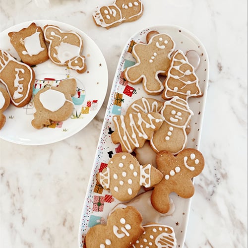 Plate of Christmas gingerbread cookies on white marble bench