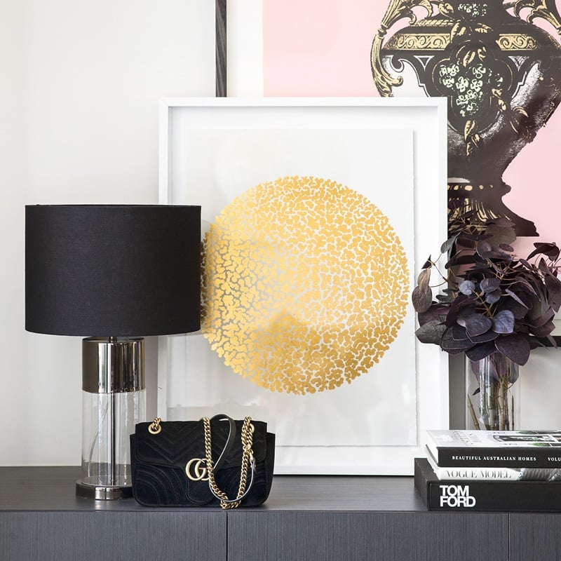 White framed gold circle artwork.