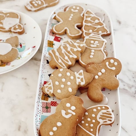 Plate of Christmas gingerbread cookies on white marble bench