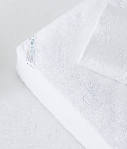 Bird’s eye view of Bamboo Mattress Protector on a bed with a pillow on top with a Bamboo Pillow Protector. 