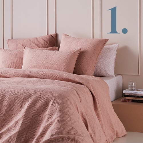 Prism Quilted Nude Quilt Cover styled with nude pink printed sheets. 