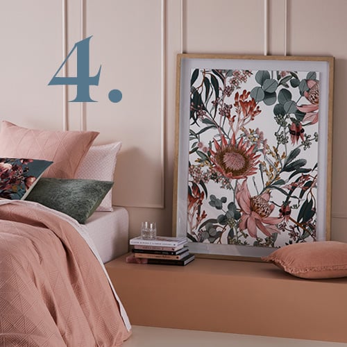 Bed styled with Prism Quilted Nude Quilt Cover, matching pillowcases, printed cushions and botanical wall art.