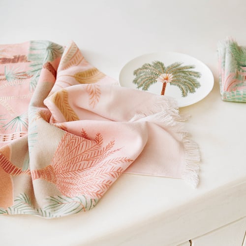 Karina Jambrak x Adairs Tea Towel on bench next to matching plate. 