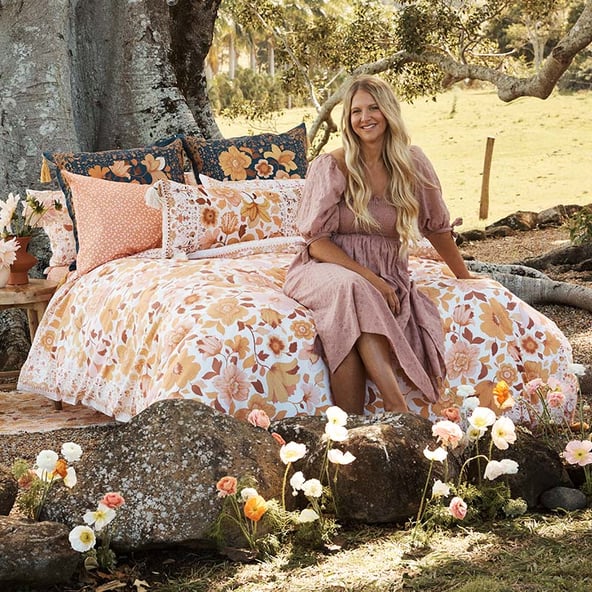 Sharnee Thorpe on location on a bed with her new collection.
