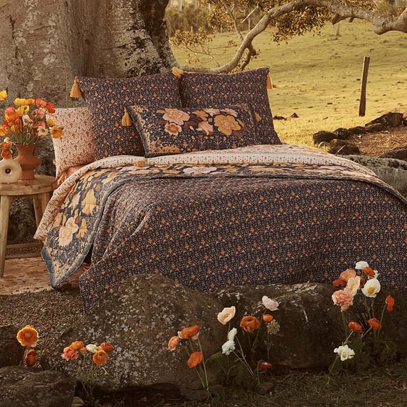 Bed styled with vintage florals in collection.