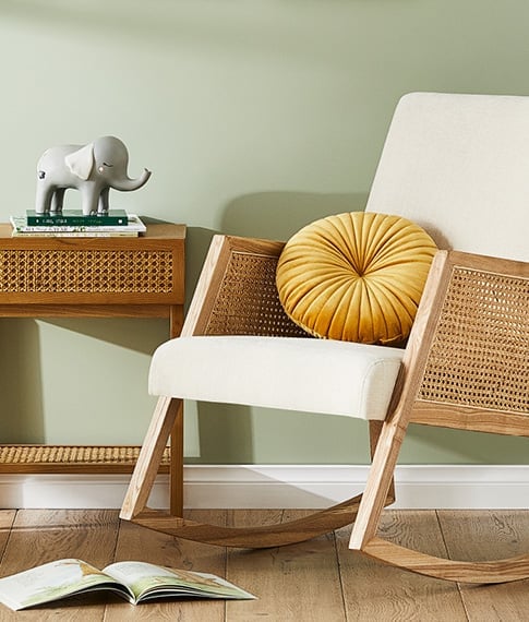Nursery Arden Natural Rattan Rocking Chair and matching Side Table with an Elephant Night Light on the table.