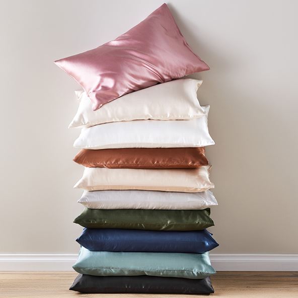 A pile of 10 pillows, each in a different colour.