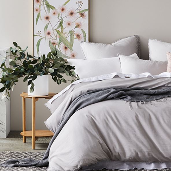 bed with grey bamboo set pillows, sheet and throw