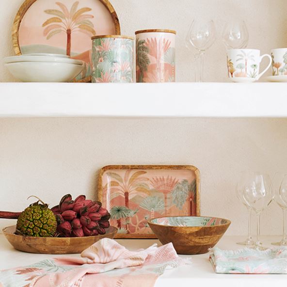 Karina Jambrak x Adairs servingware across two shelves including serving trays, bowl, tea towels, cannisters and more. 