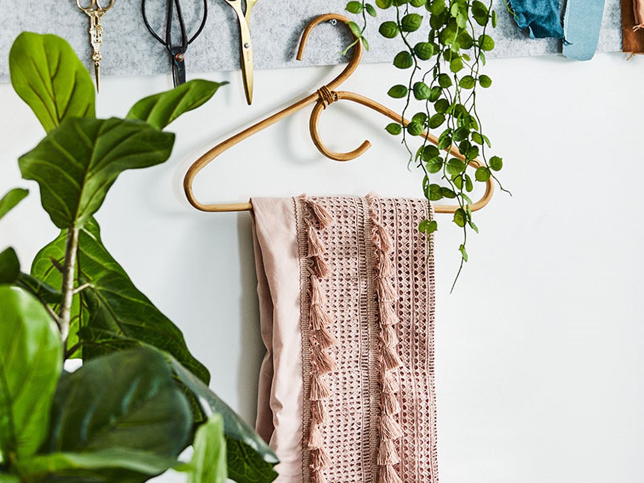 A coat hanger that’s pinned onto a mood board with a unique pattern sheet hanging off