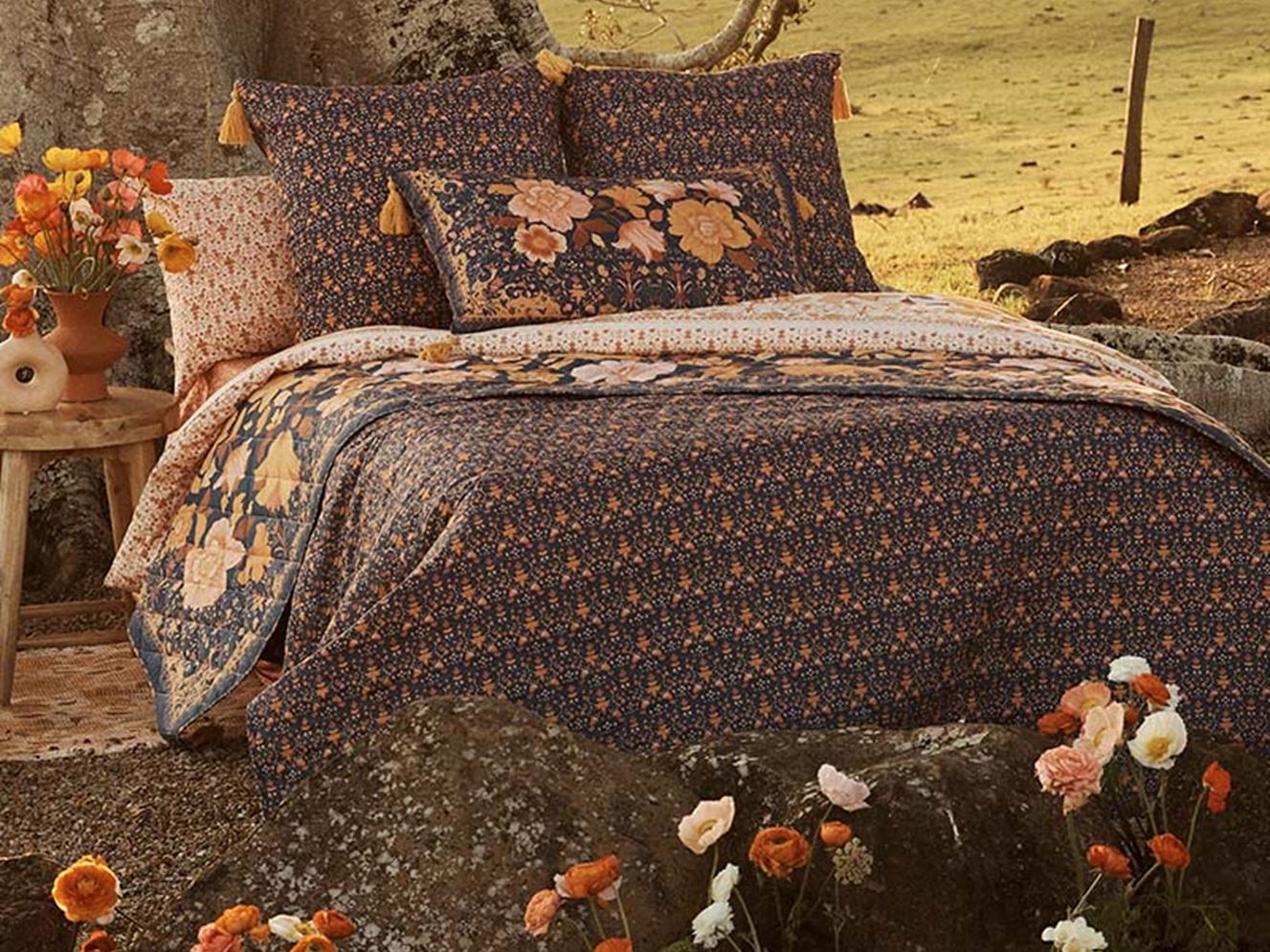 Bed styled with vintage florals in collection.