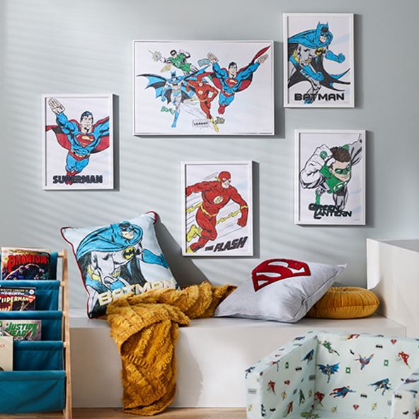 Justice League wall art hanging on walls and on a seating ledge matching cushions are styled together. 