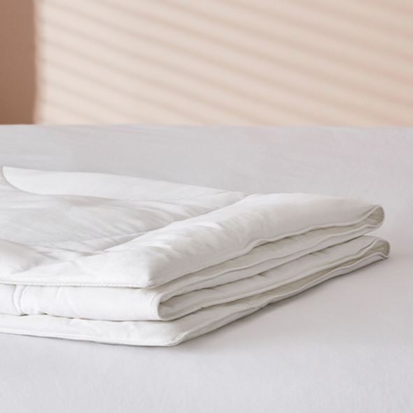 Adairs Kids Bamboo Mattress Protector, folded demonstrating the thickness and padding of the product.