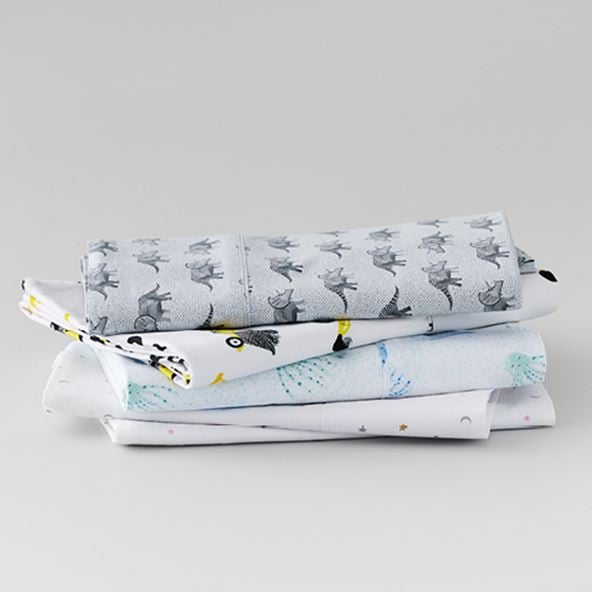 various kids sheets stacked on top of each other in animal print patterns
