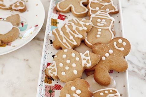 Plate of Christmas gingerbread cookies on white marble bench