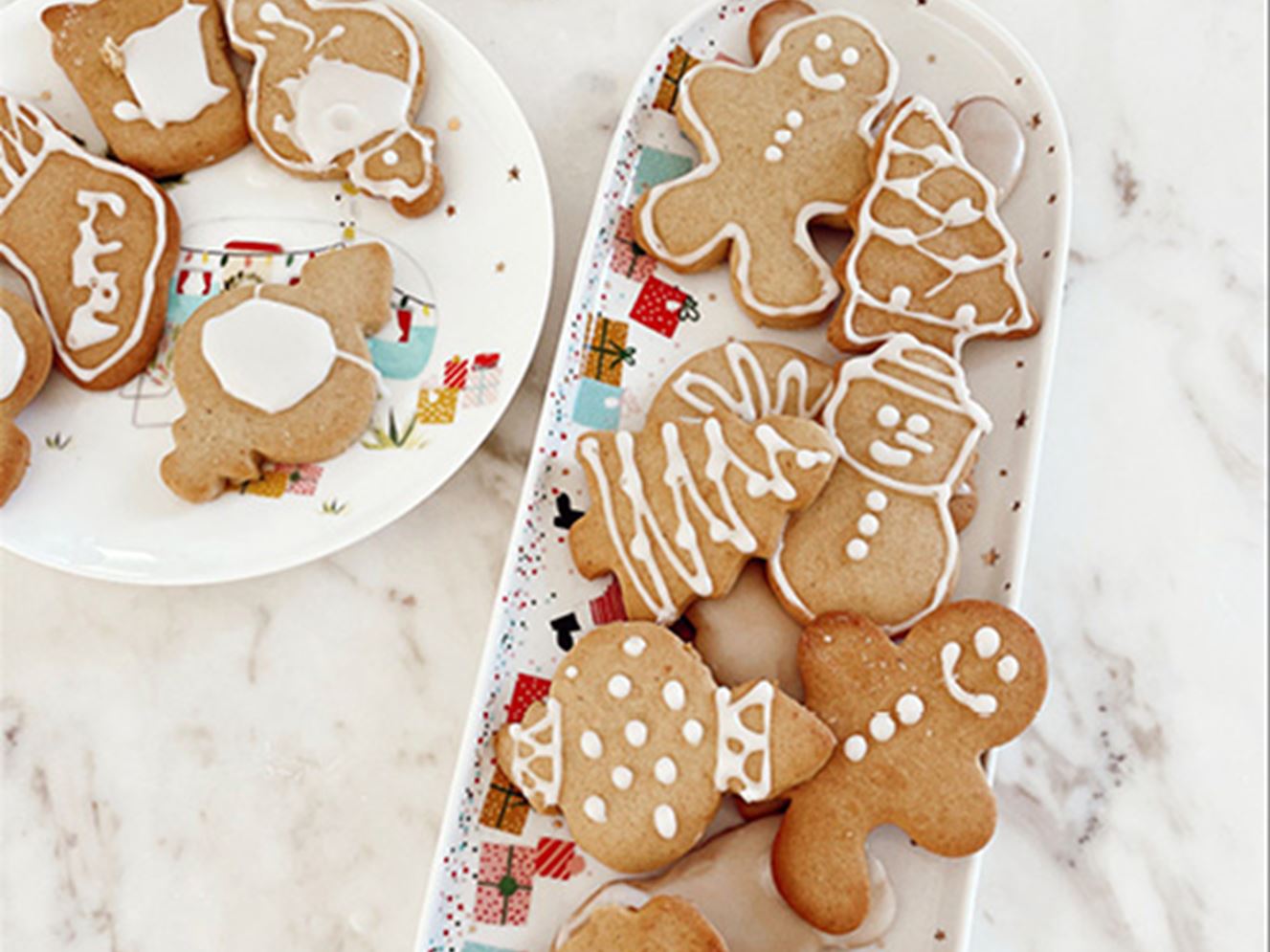 Plate of Christmas gingerbread cookies on white marble bench